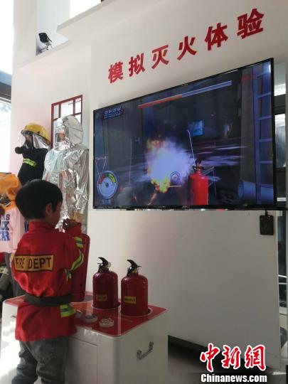 圖為一名小學(xué)生體驗(yàn)?zāi)M滅火 劉鵬 攝